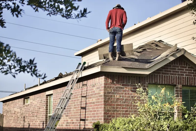 Professional roofer working on a residential roof in Conway Farms